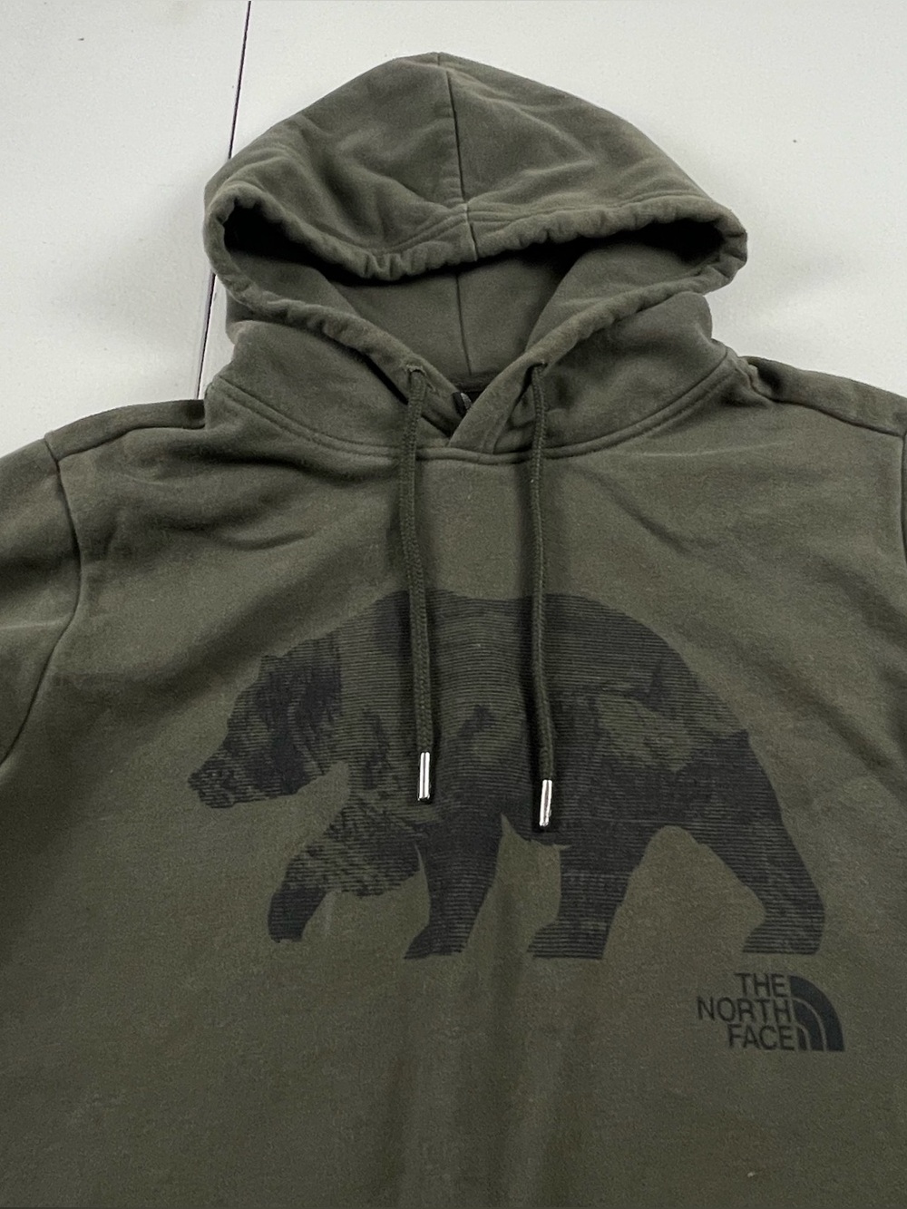 The North Fave Evolution Bear Hoodie. Size small Unisex Olive Green